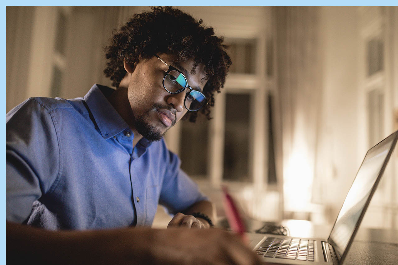 man studying with laptop